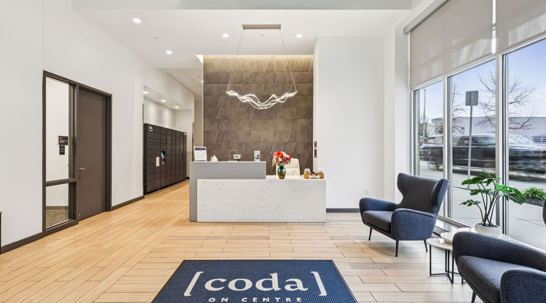 bright lobby with concierge desk and Amazon Hub lockers