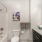 Large well lit bathroom with white accents 
