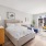 bedroom with a large window and modern decor